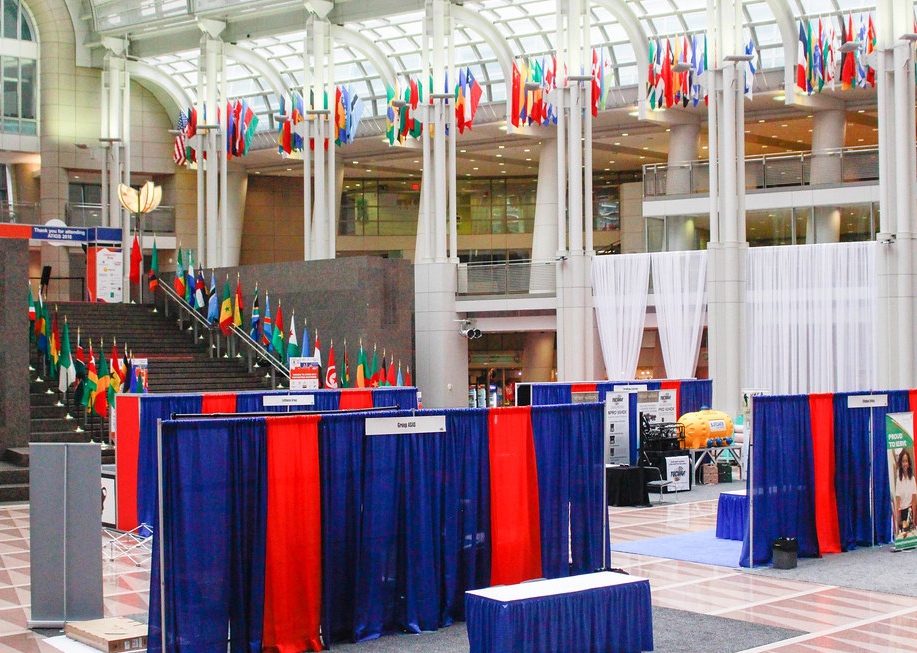 ATIGS exhibition hall lined with international flags and exhibitor booths