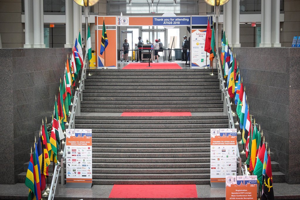 Delegate arrival with 85+ national flags on the summit approach